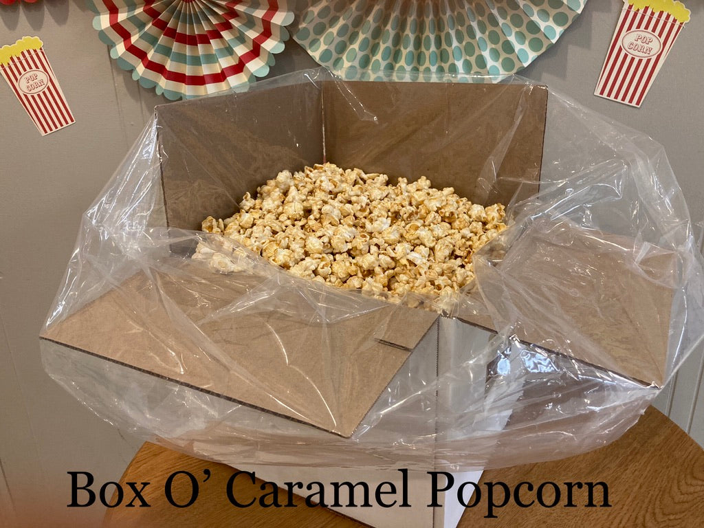Caramel popcorn in a bag inside a shipping box